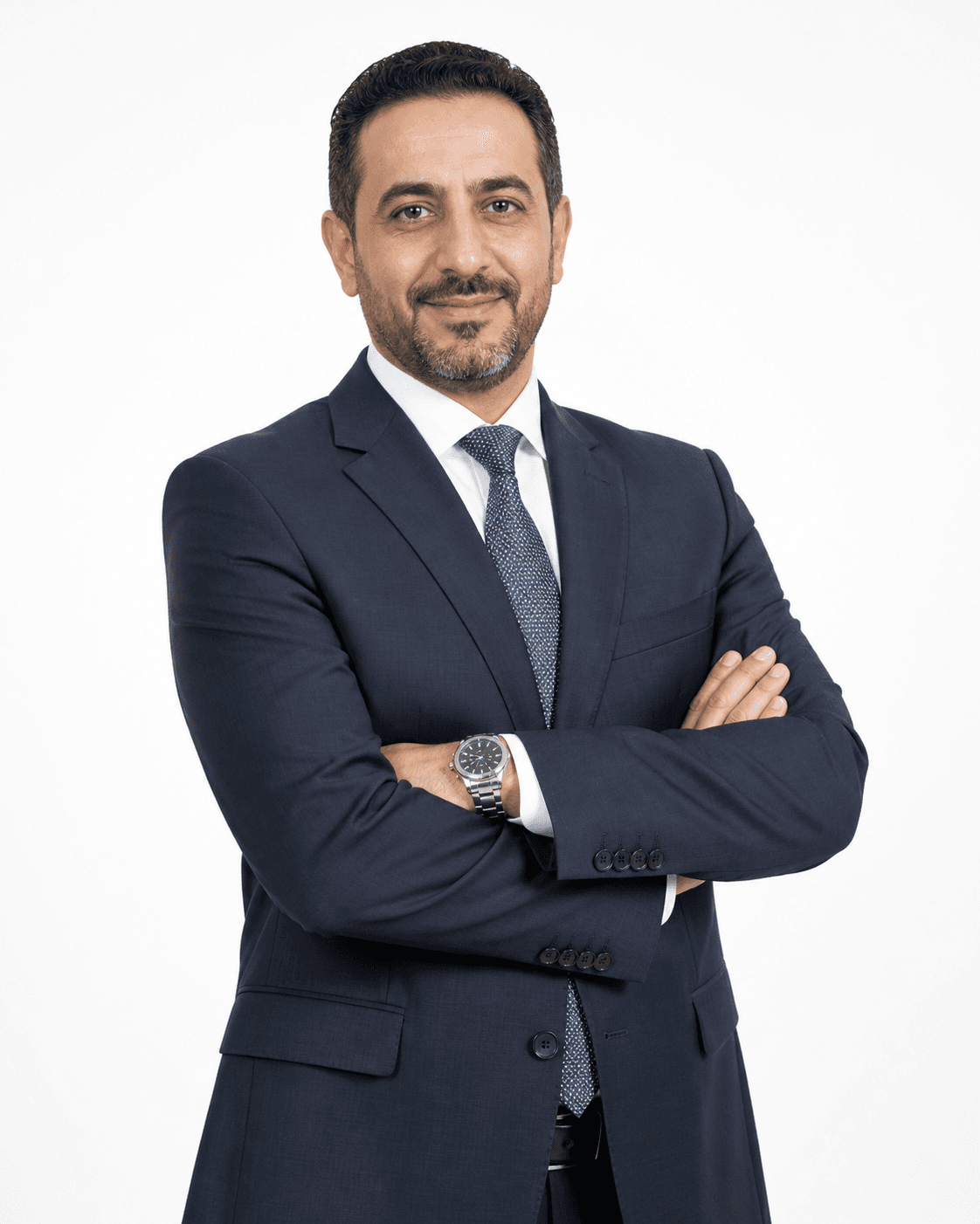 Portrait of Dr. Karim Saadi in a navy suit and tie with arms crossed