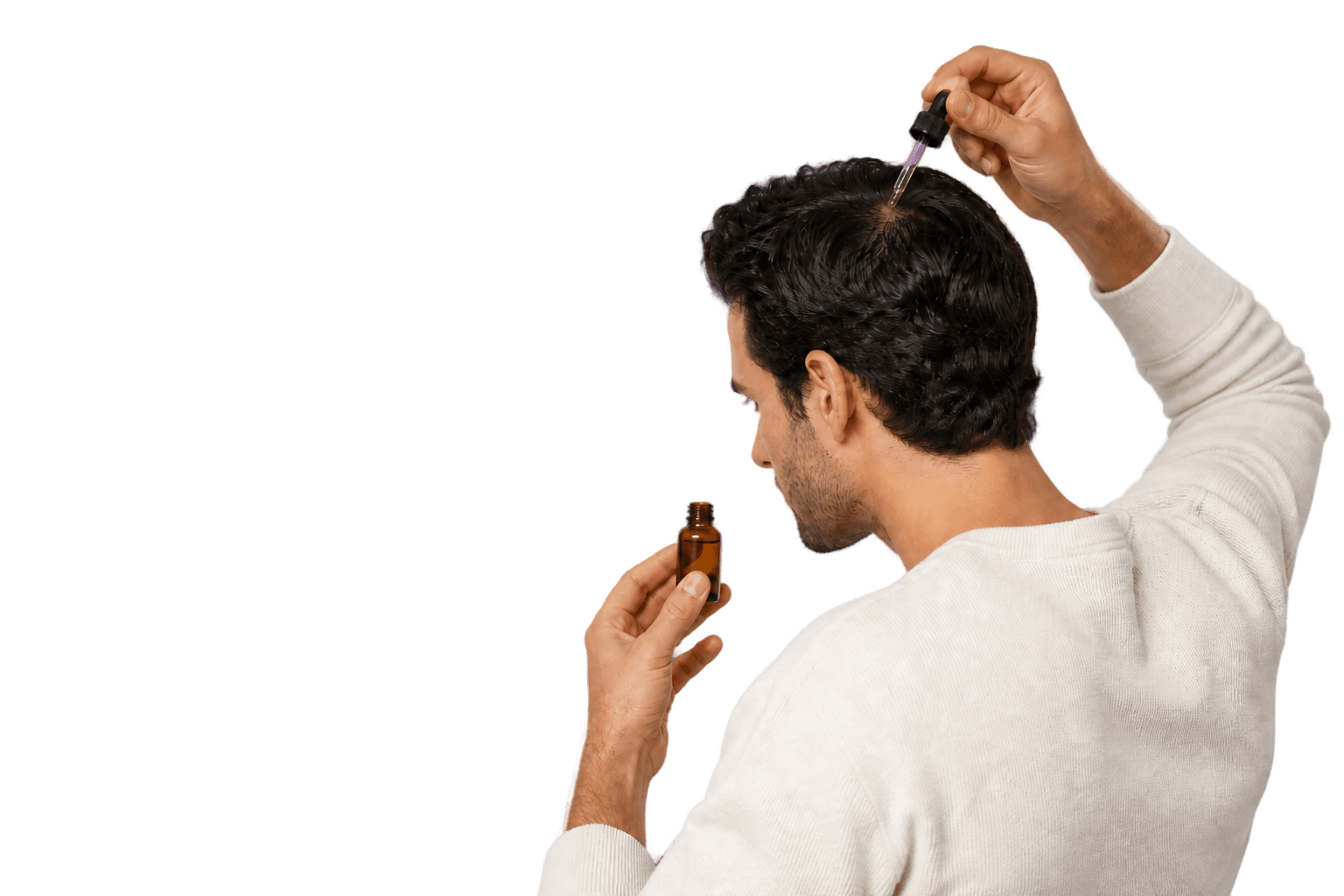 Man applying hair treatment serum to scalp