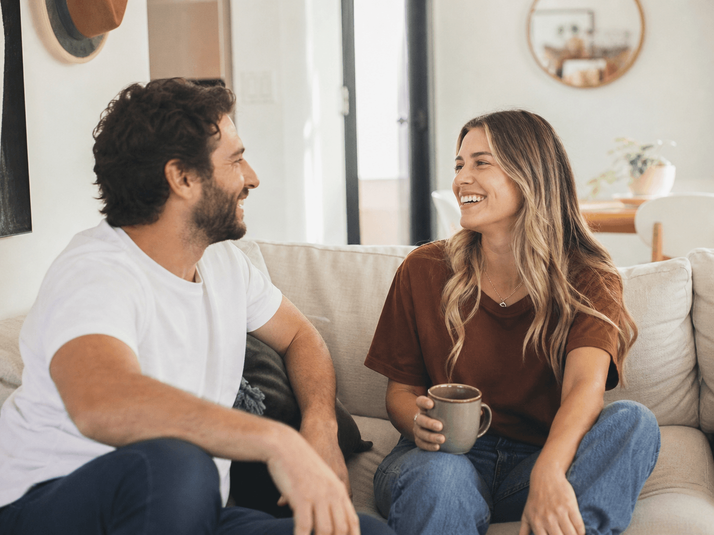 Two people talking on a couch during a weight-loss care conversation